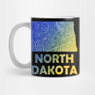 Colorful mandala art map of North Dakota with text in blue and yellow Mug